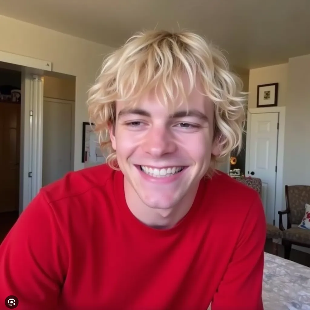 Ross Lynch with red shirt He appears smiling showing teeth in video call Interview in bedroom in Littleton ,  Colorado