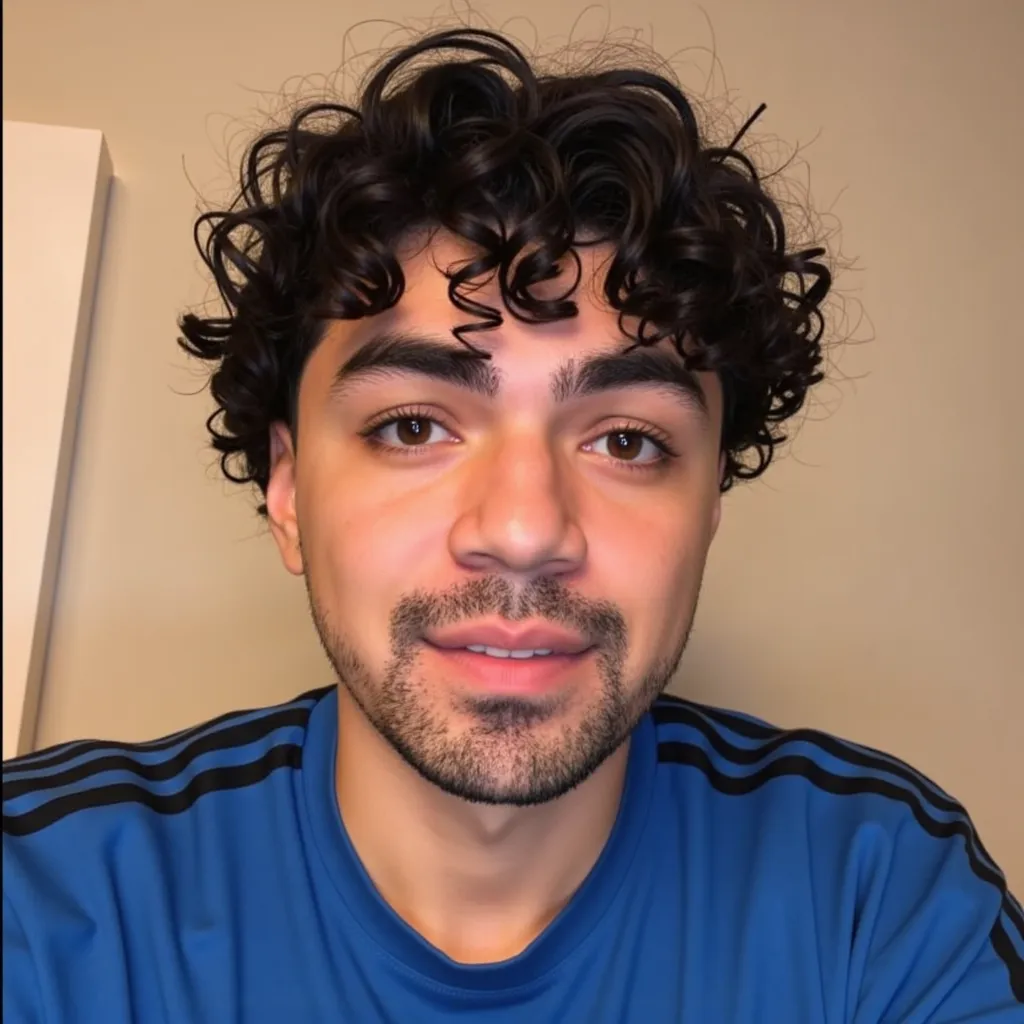 Adam Irigoyen  with blue shirt with black stripes He appears smiling showing teeth in video call Interview in London